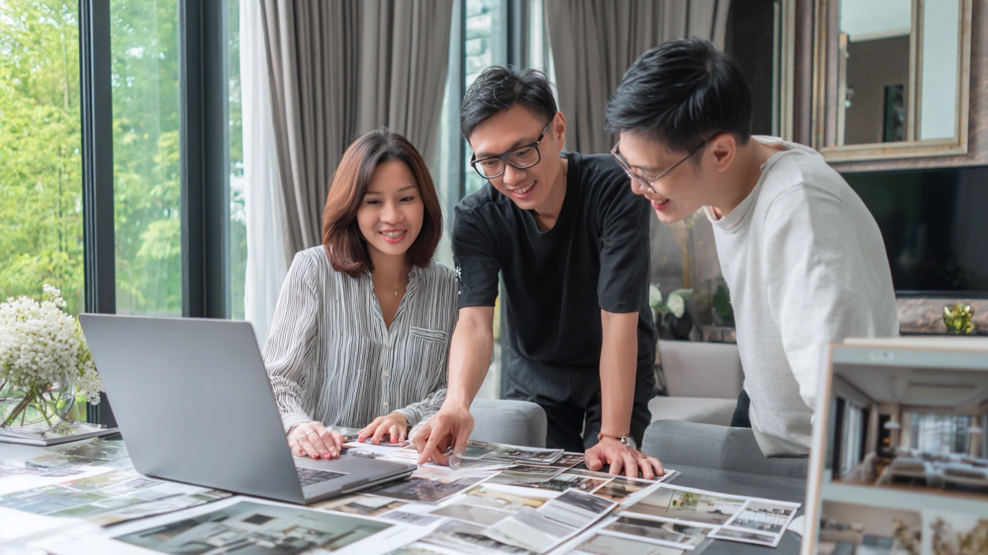 Interior designer presenting wardrobe layout options to Malaysian homeowners during renovation planning Interior designer presenting wardrobe layout options to Malaysian homeowners during renovation planning